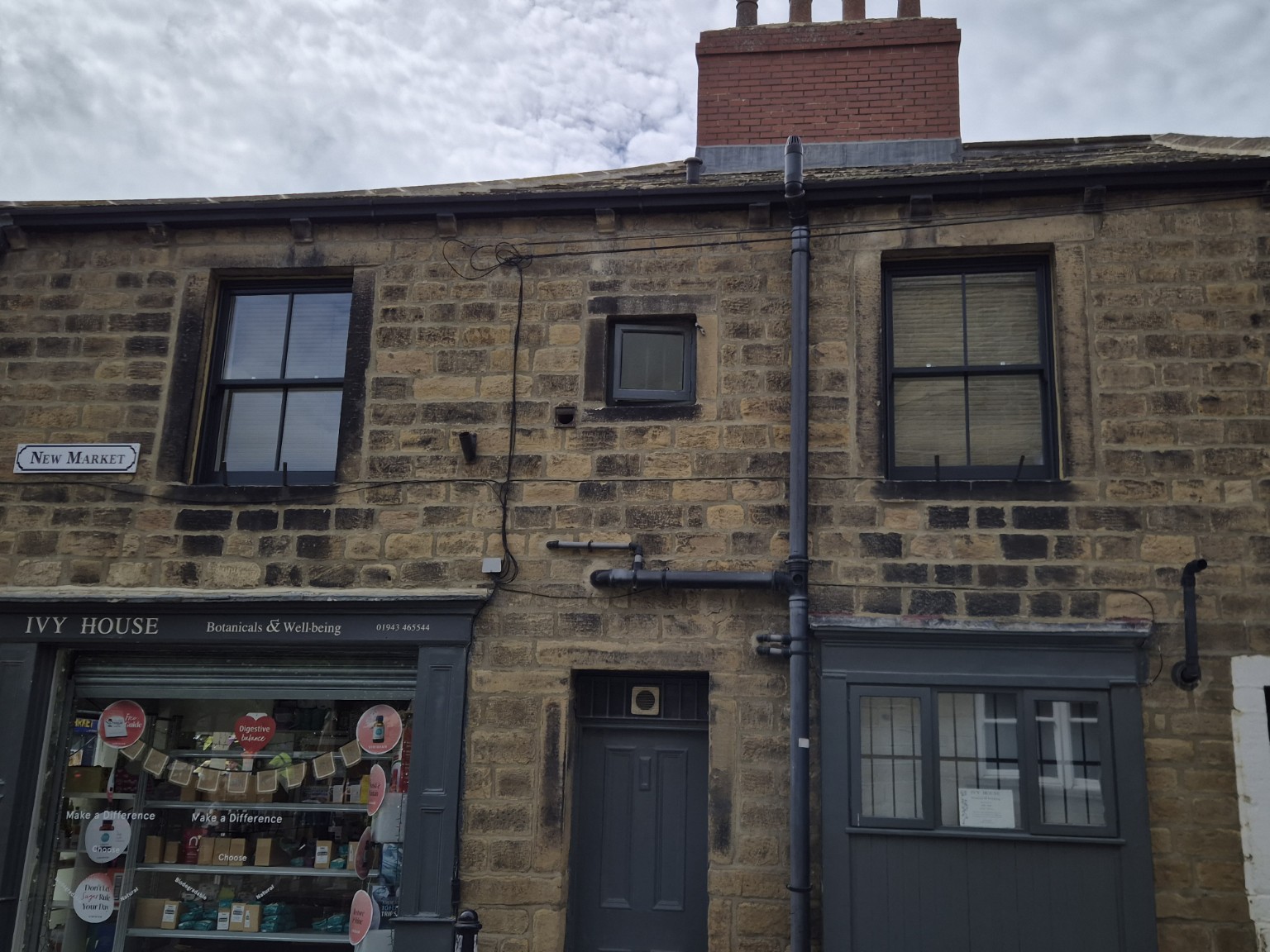 Traditional style dark timber sash window fitted into stonework
